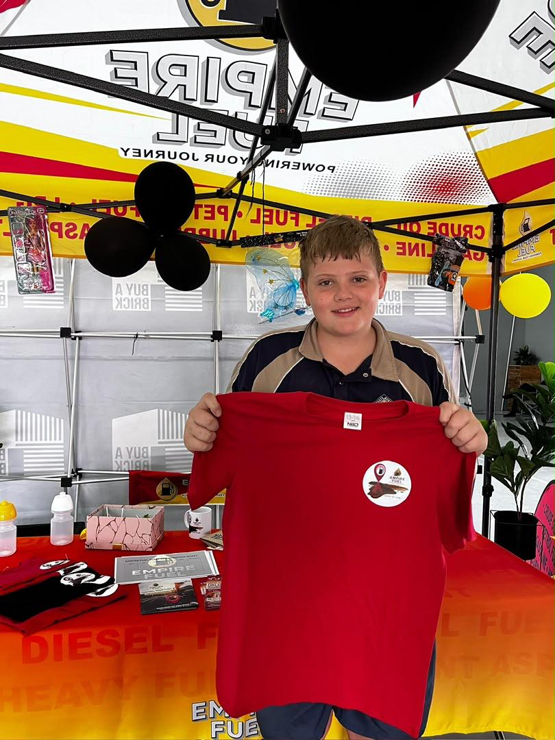 A young player holding his sponsored Empire Fuel jersey