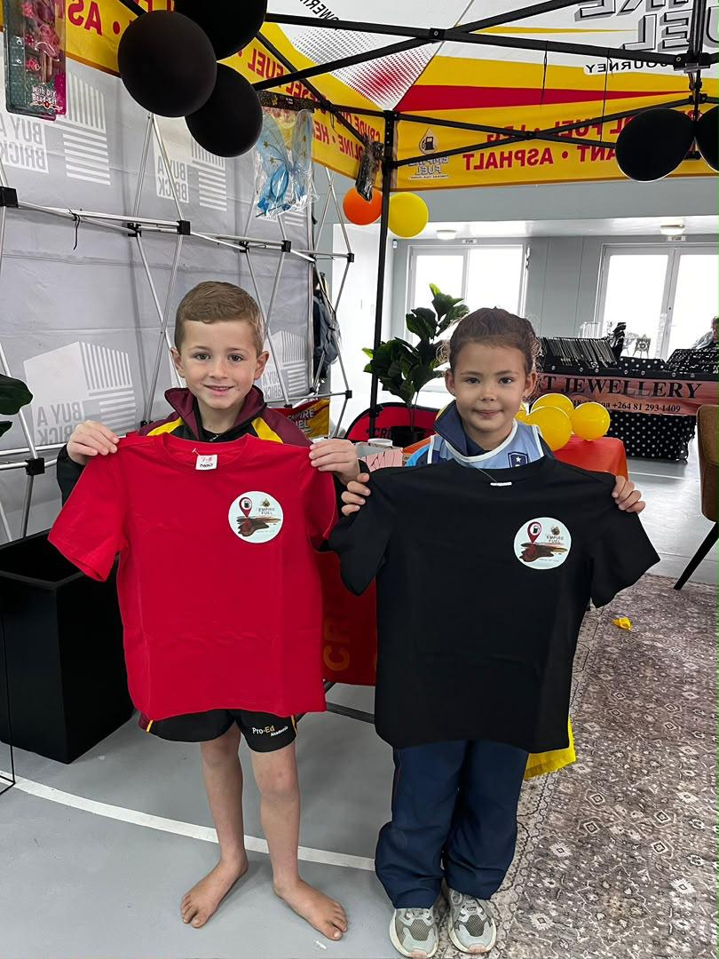 Young team members holding their sponsored jerseys